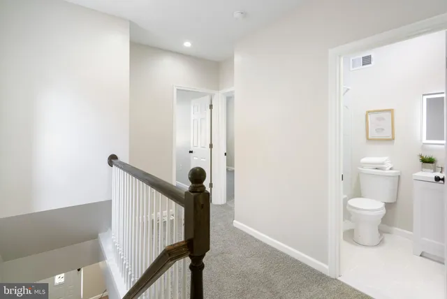 a very nice looking room with a chair and a toilet