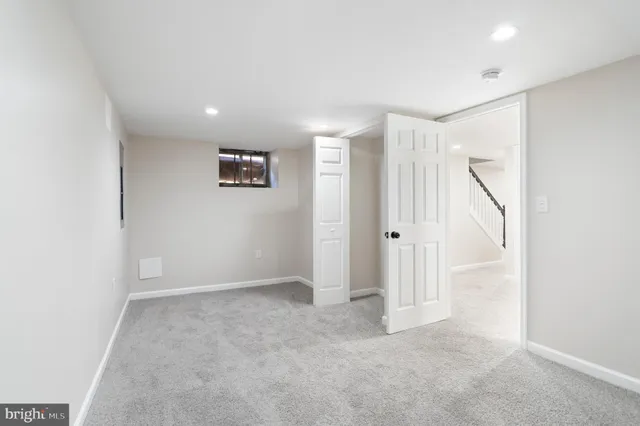 an empty room with windows and closet