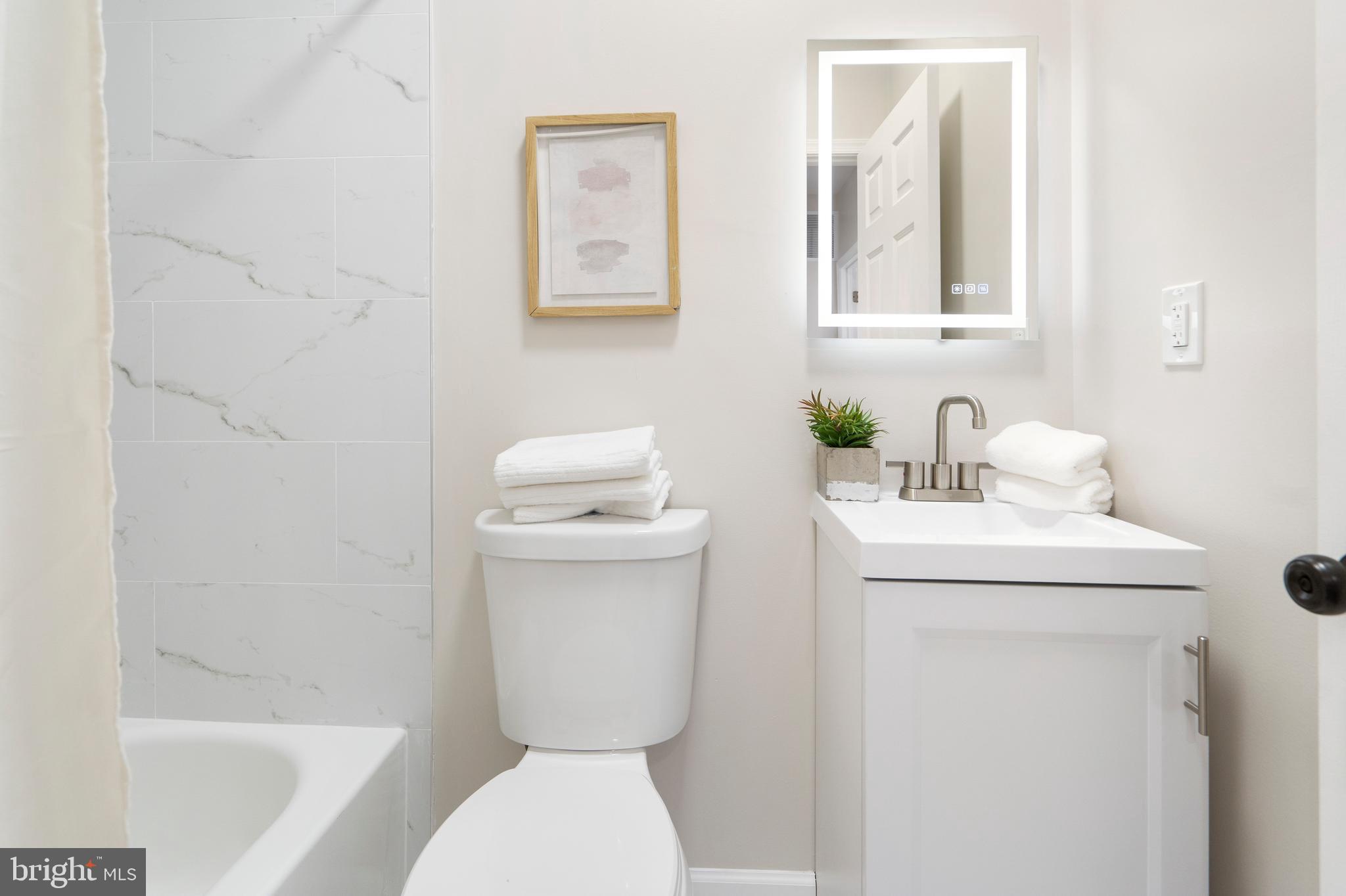 4011 Ridgewood Avenue Baltimore, MD 21215 - Photo 29 of 35 a bathroom with a toilet sink and mirror