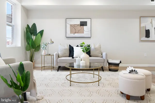 a living room with furniture and a potted plant