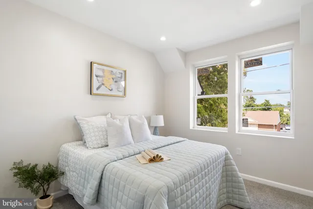 a bedroom with a bed and a lamp on table