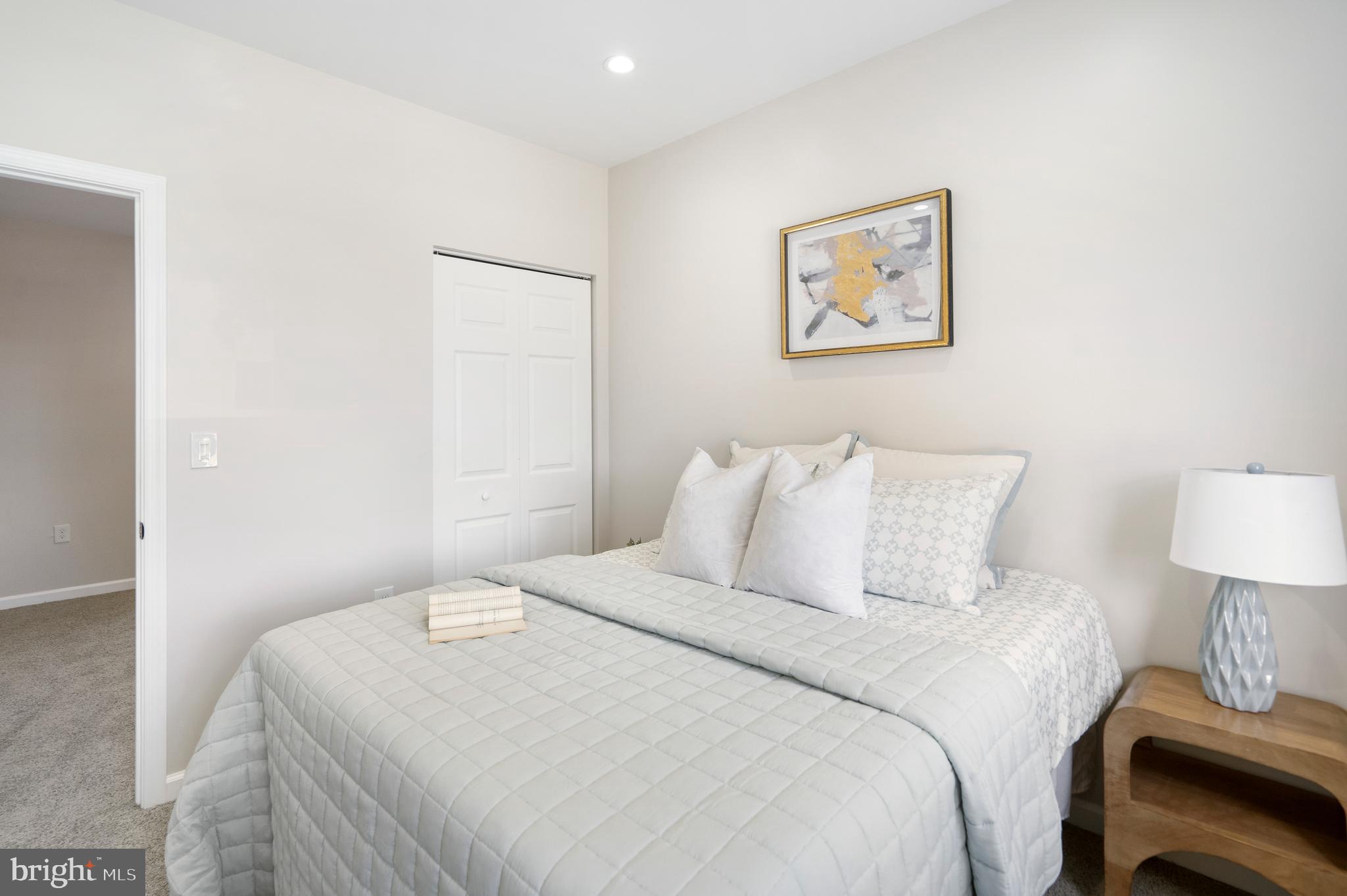 4011 Ridgewood Avenue Baltimore, MD 21215 - Photo 32 of 35 a bedroom with a bed and a lamp on table