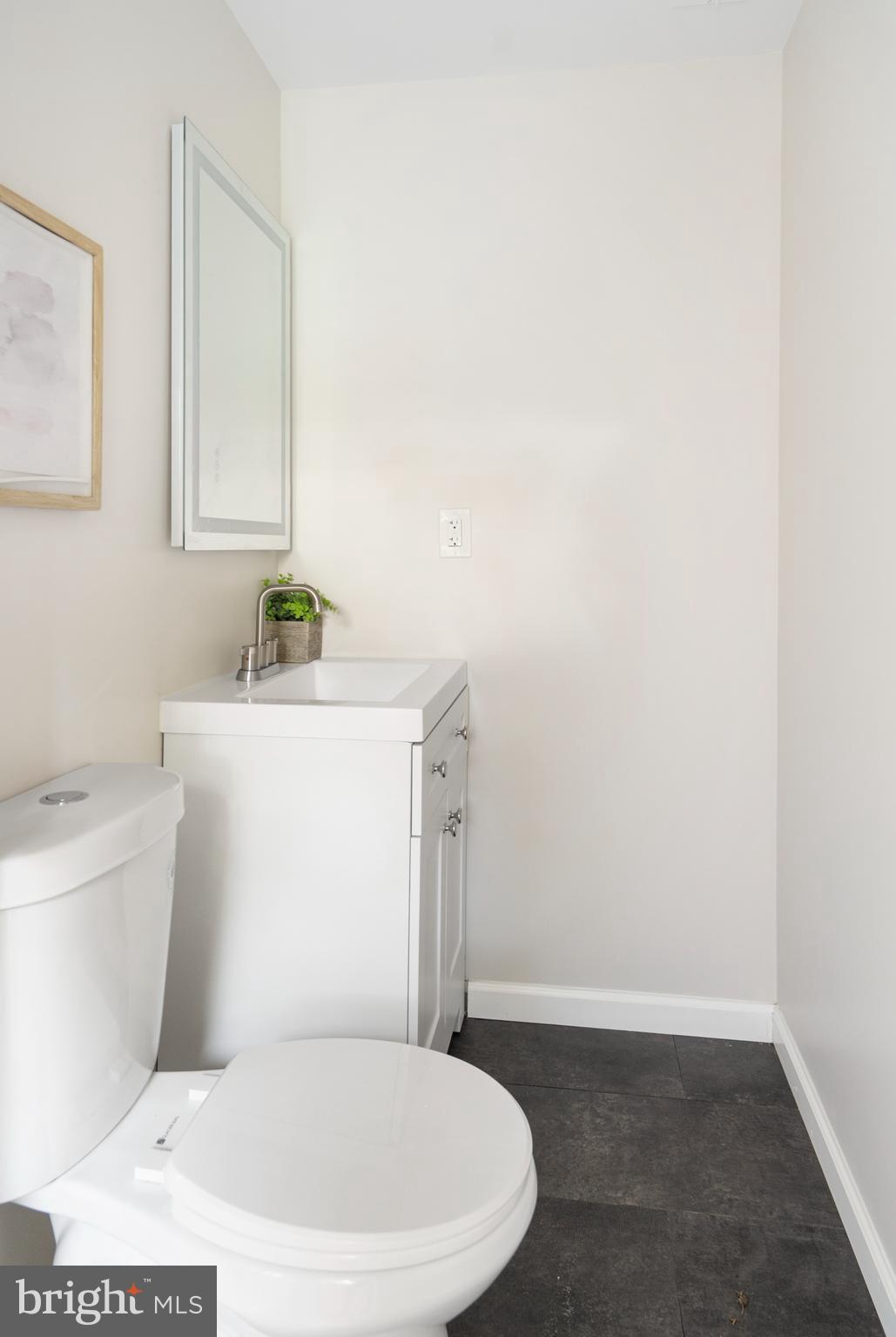 4011 Ridgewood Avenue Baltimore, MD 21215 - Photo 35 of 35 a white toilet sitting next to a bathroom sink