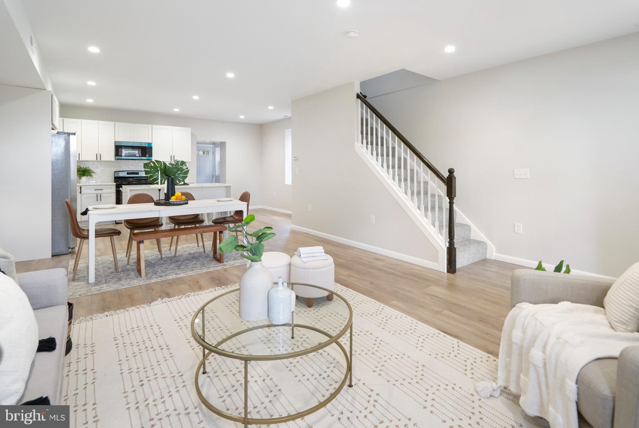 4011 Ridgewood Avenue Baltimore, MD 21215 - Photo 5 of 35 a living room with furniture and a dining table with wooden floor
