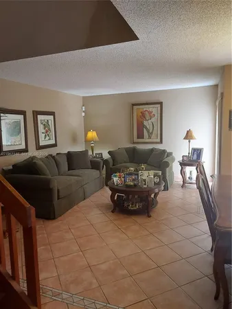 a living room with furniture and a lamp