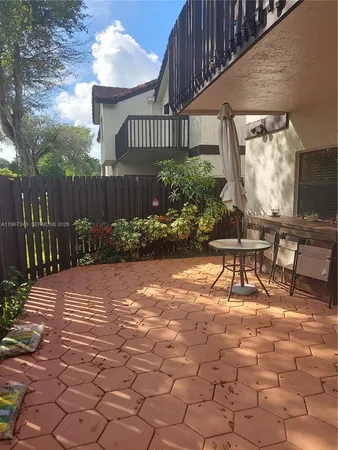 a view of a chairs and table in backyard