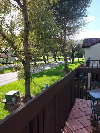 a view of a wooden deck and a backyard