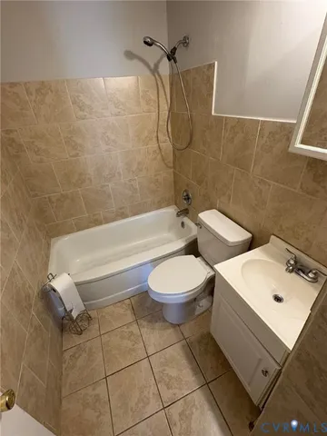 a bathroom with a toilet a sink and bathtub