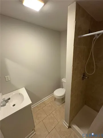 a bathroom with a granite countertop sink a toilet and a shower
