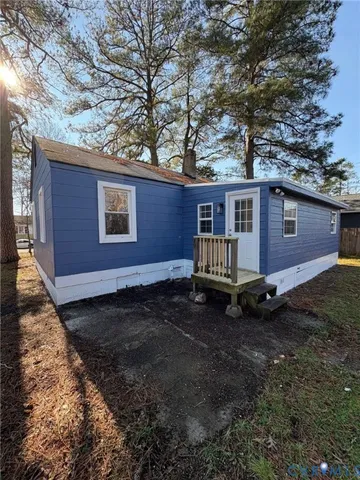 a view of a house with a yard siting area and wooden fence