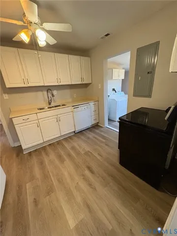 a kitchen with granite countertop cabinets and wooden floor
