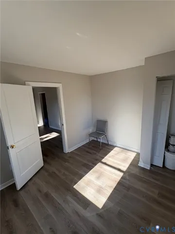 a view of a room with wooden floor and bathroom