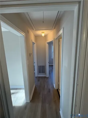 a view of hallway with wooden floor