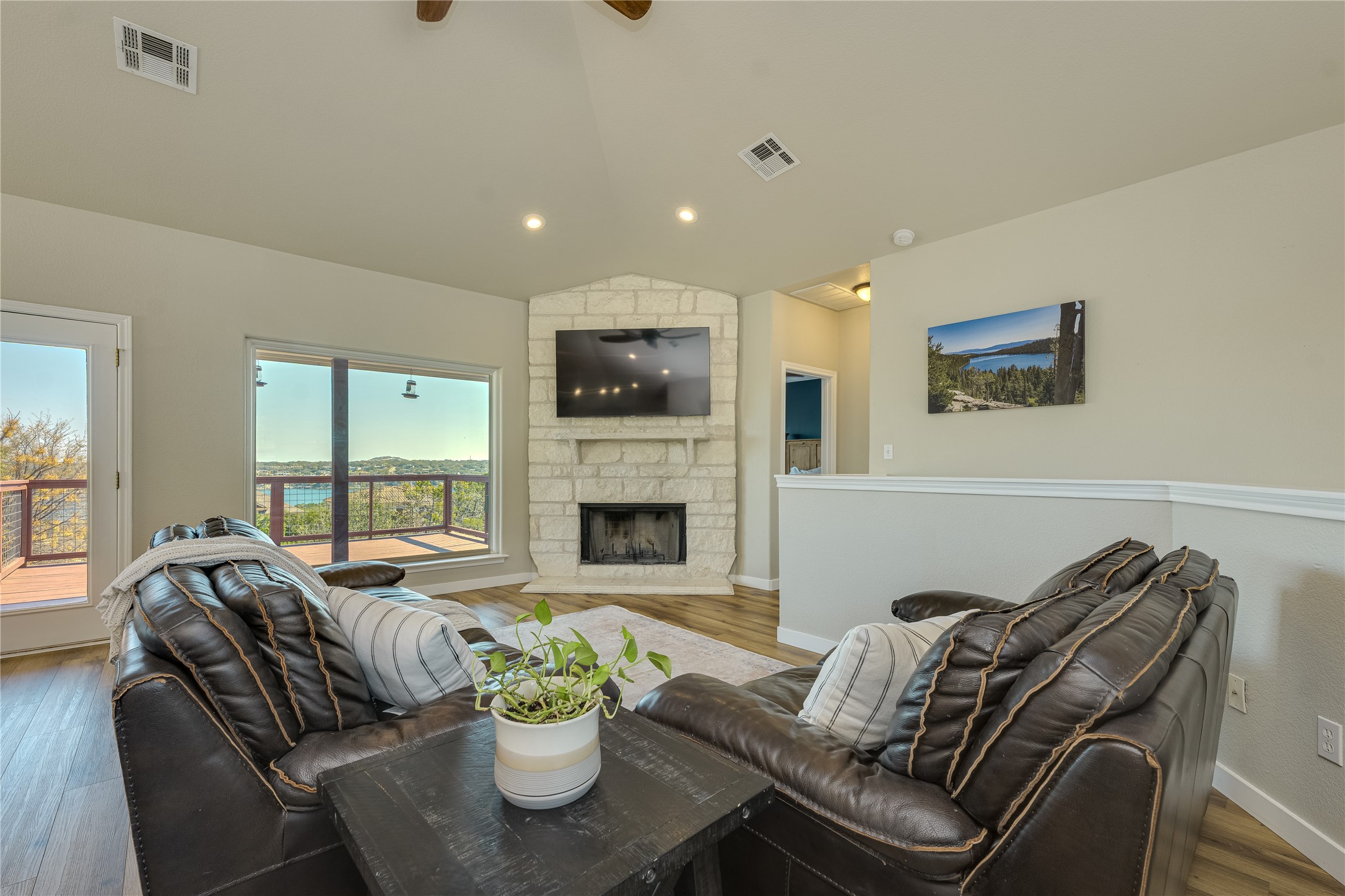 330 Southwind Road Point Venture, TX 78645 - Photo 5 of 39 Kick back by the fireplace, then remember you’re at a lake house thanks to the views.