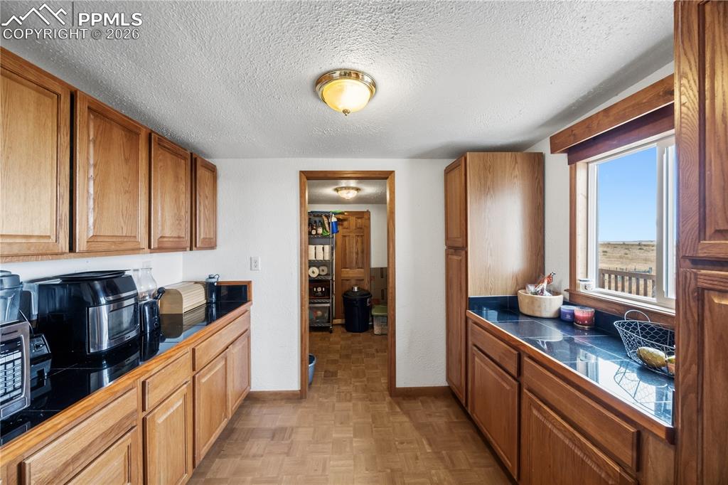 6615 Mulberry Road Calhan, CO 80808 - Photo 11 of 47 a kitchen with stainless steel appliances granite countertop a refrigerator and a stove top oven
