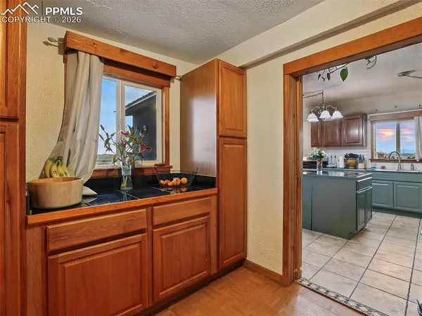 a kitchen with stainless steel appliances kitchen island granite countertop a refrigerator and a sink