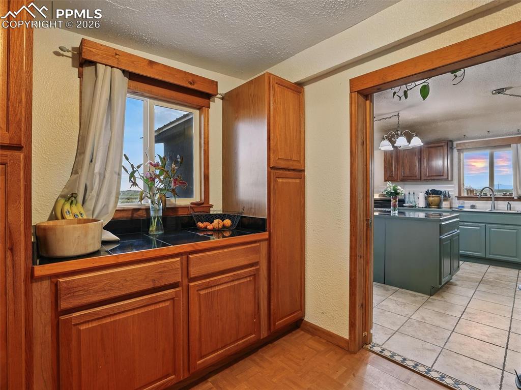 6615 Mulberry Road Calhan, CO 80808 - Photo 13 of 47 a kitchen with stainless steel appliances kitchen island granite countertop a refrigerator and a sink