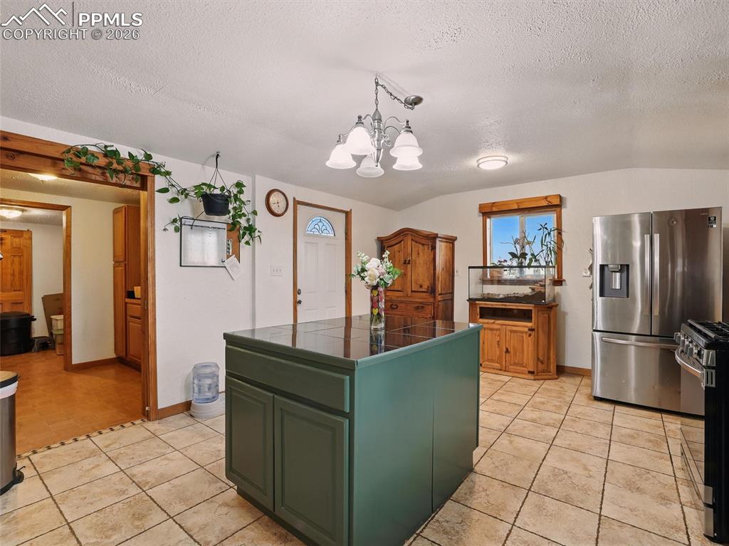 6615 Mulberry Road Calhan, CO 80808 - Photo 14 of 47 a kitchen with stainless steel appliances granite countertop a refrigerator and a sink