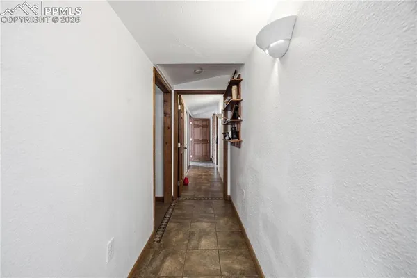 a bedroom with a large bed and a ceiling fan