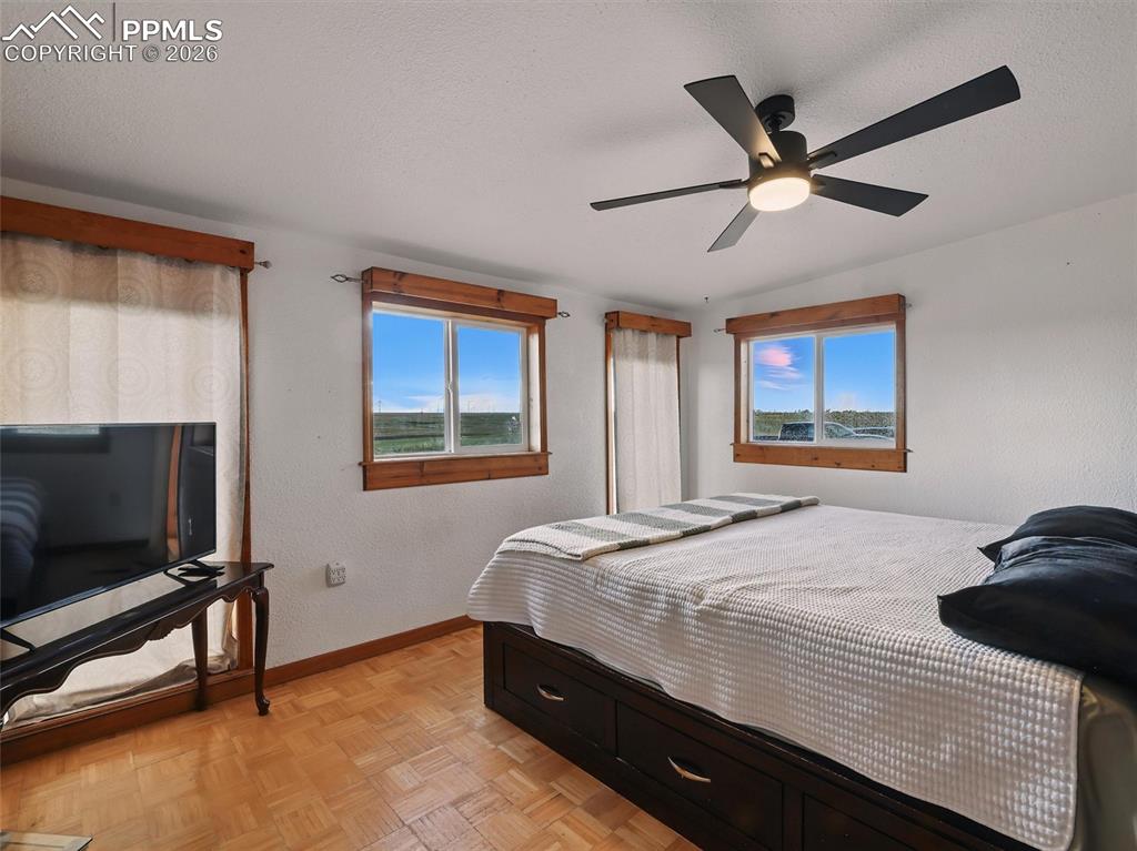 6615 Mulberry Road Calhan, CO 80808 - Photo 23 of 47 a bedroom with a bed and a flat screen tv
