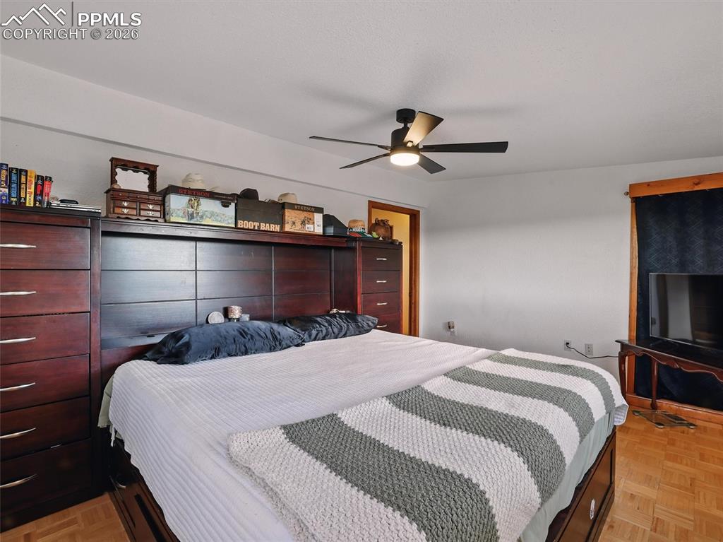 6615 Mulberry Road Calhan, CO 80808 - Photo 24 of 47 a bedroom with a large bed and a ceiling fan