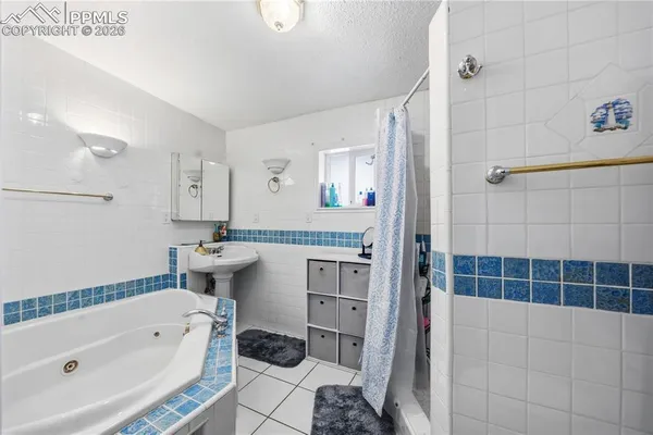 a bedroom with a bed mirror and a window