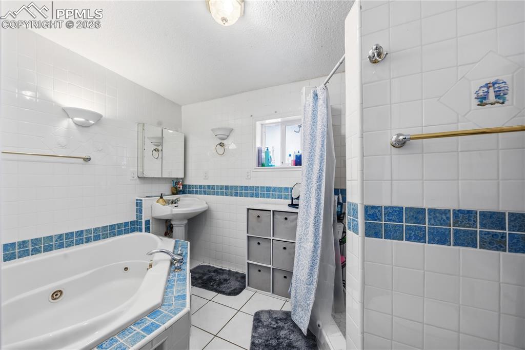 6615 Mulberry Road Calhan, CO 80808 - Photo 26 of 47 a bathroom with a tub sink and mirror