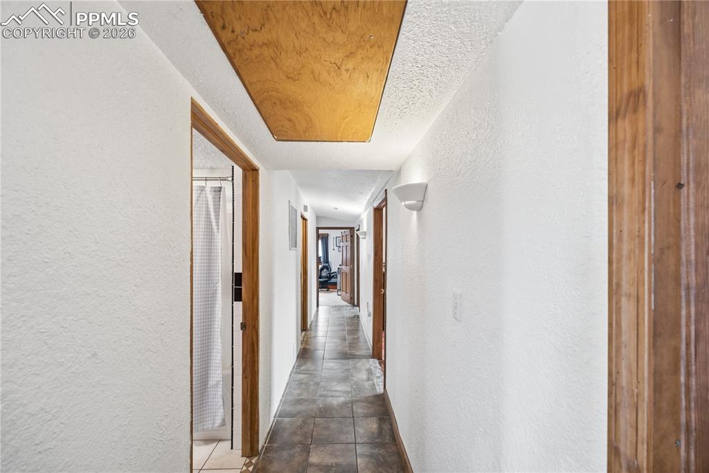 6615 Mulberry Road Calhan, CO 80808 - Photo 27 of 47 a view of a hallway with wooden floor and glass door