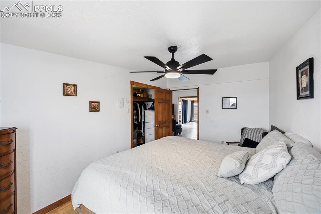 6615 Mulberry Road Calhan, CO 80808 - Photo 29 of 47 a bedroom with a large bed and a chandelier