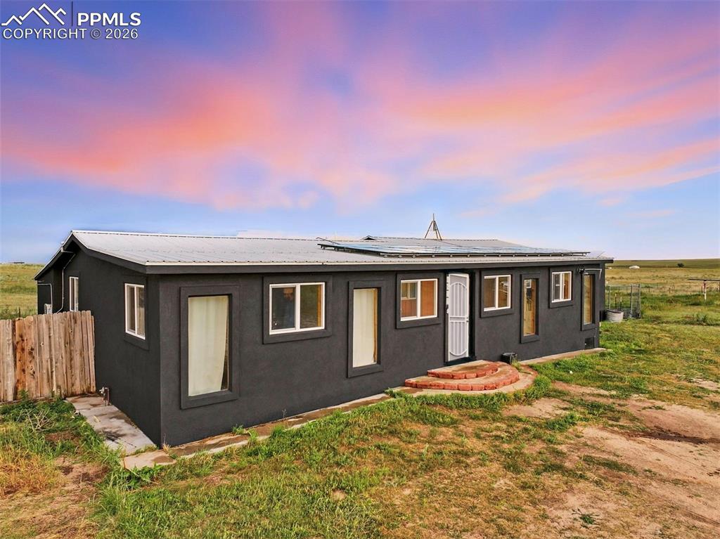 6615 Mulberry Road Calhan, CO 80808 - Photo 3 of 47 a front view of a house with a yard