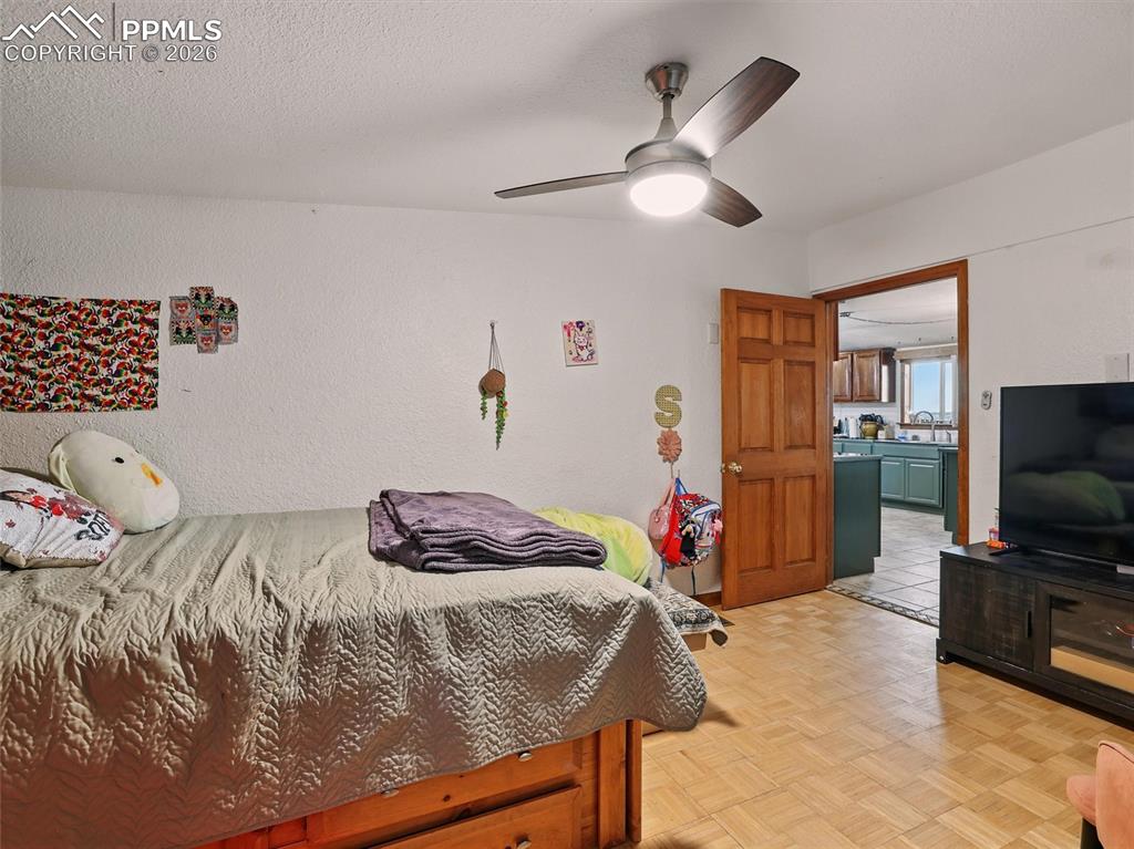 6615 Mulberry Road Calhan, CO 80808 - Photo 34 of 47 a bedroom with a bed and a flat screen tv