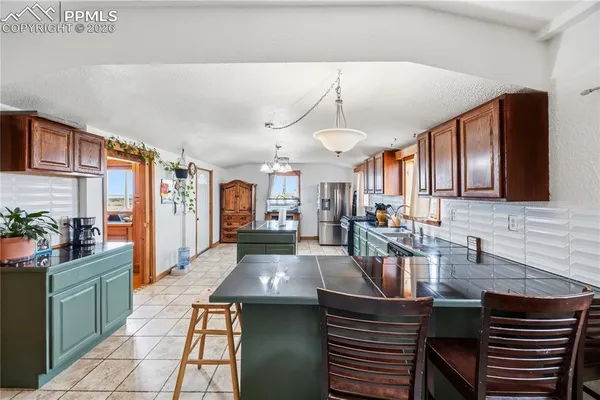 a kitchen with a table chairs stove and cabinets