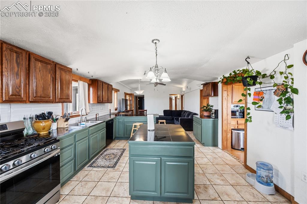 6615 Mulberry Road Calhan, CO 80808 - Photo 9 of 47 a kitchen with a refrigerator and a stove top oven