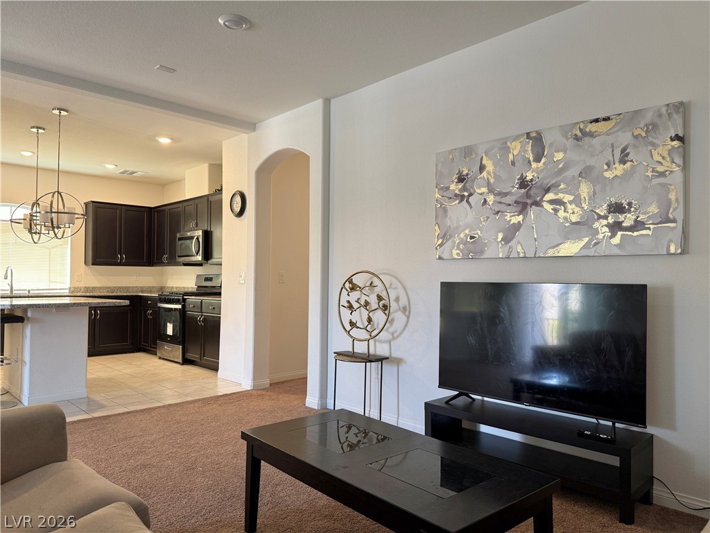 7777 South Westwind Road Las Vegas, NV 89139 - Photo 38 of 46 An inviting open-concept living space seamlessly connects to a well-appointed kitchen.
