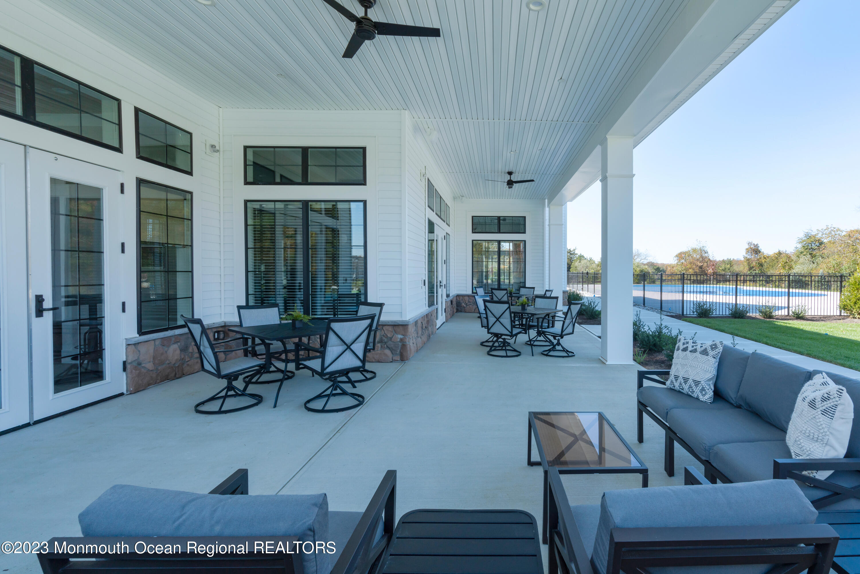 23 Gulfstream Road New Egypt, NJ 08533 - Photo 27 of 34 a view of a patio with table and chairs potted plants with wooden floor and fence