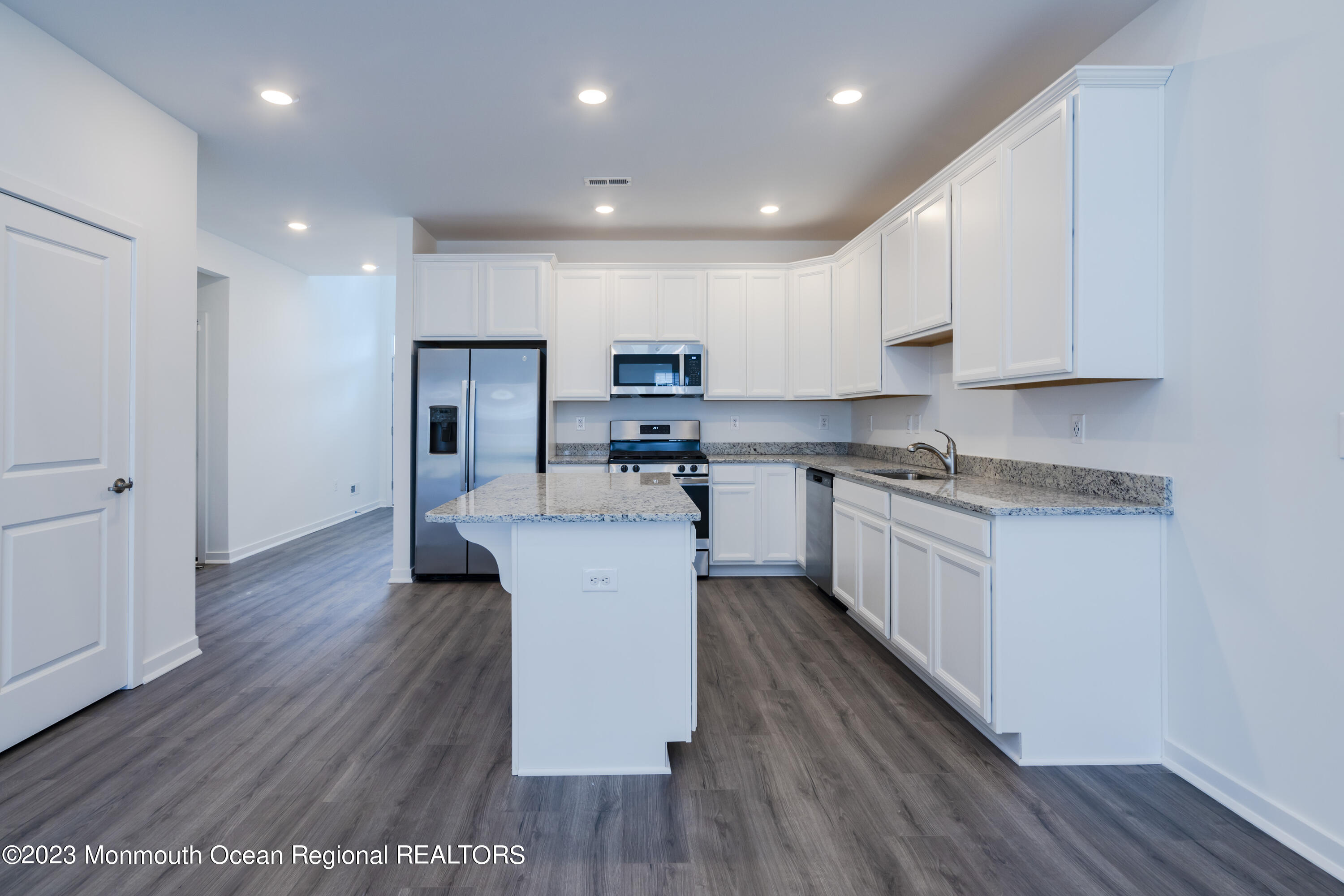 23 Gulfstream Road New Egypt, NJ 08533 - Photo 3 of 34 a kitchen with stainless steel appliances granite countertop a white cabinets and wooden floors