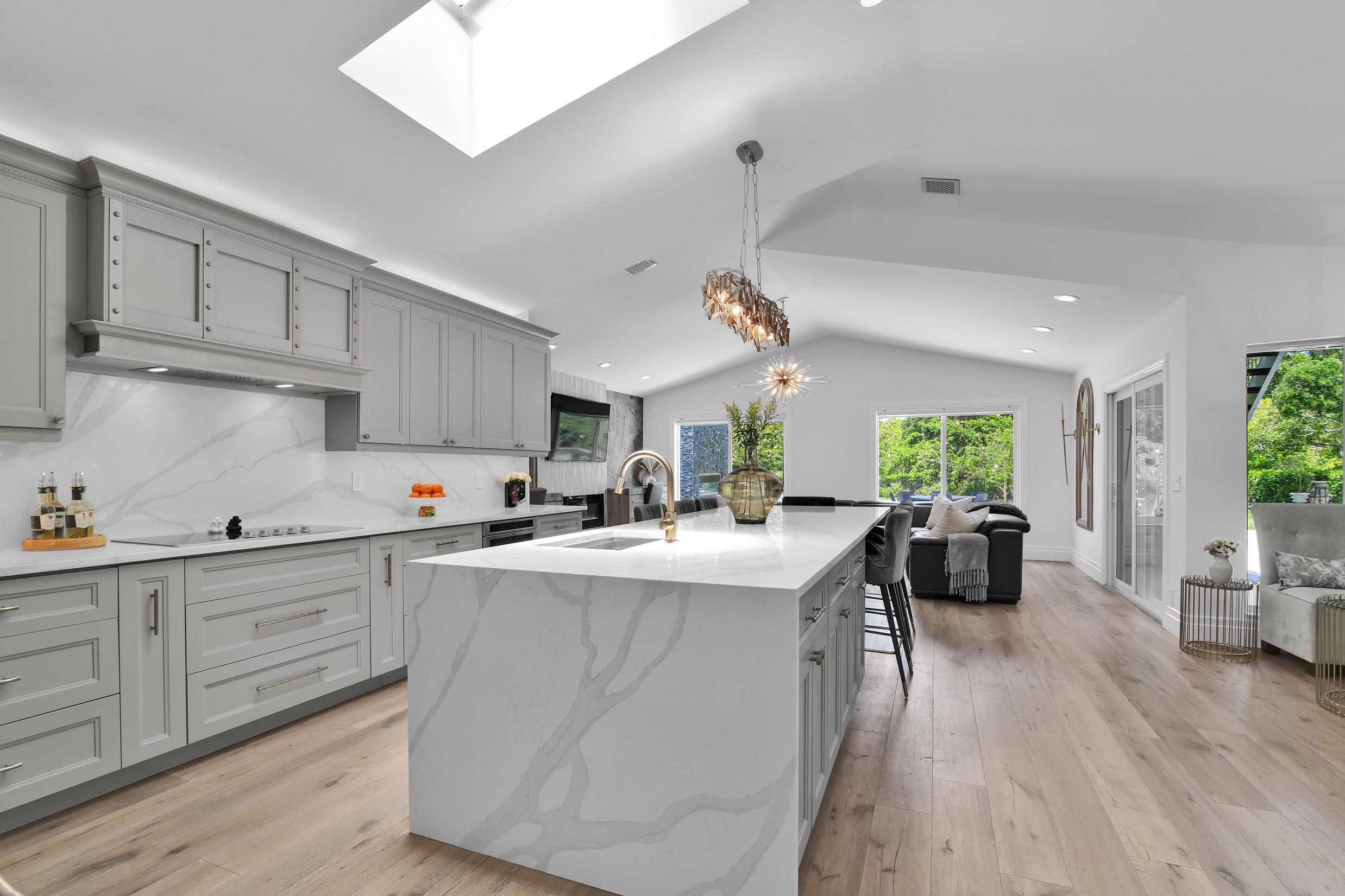 21082 North Sweetwater Lane Boca Raton, FL 33428 - Photo 14 of 75 a kitchen with sink a center island and cabinets