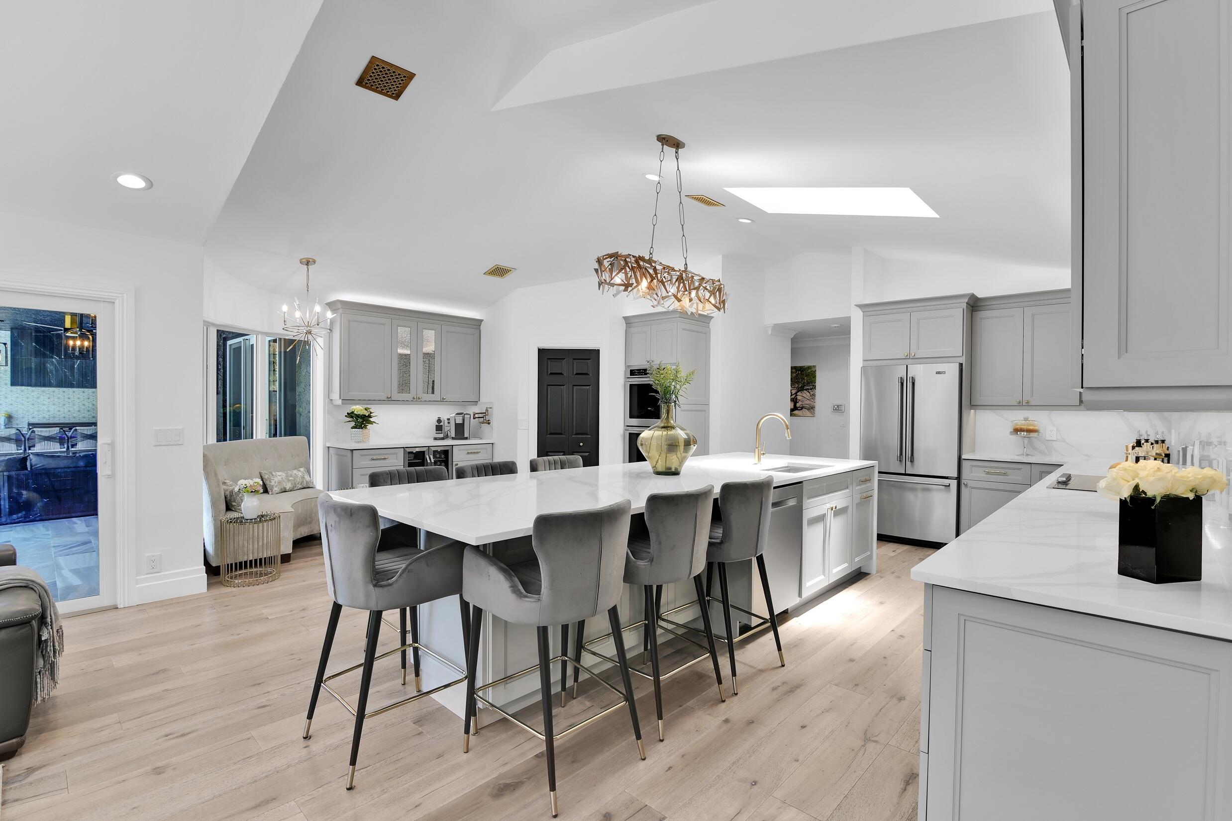 21082 North Sweetwater Lane Boca Raton, FL 33428 - Photo 18 of 75 a large kitchen with a table and chairs