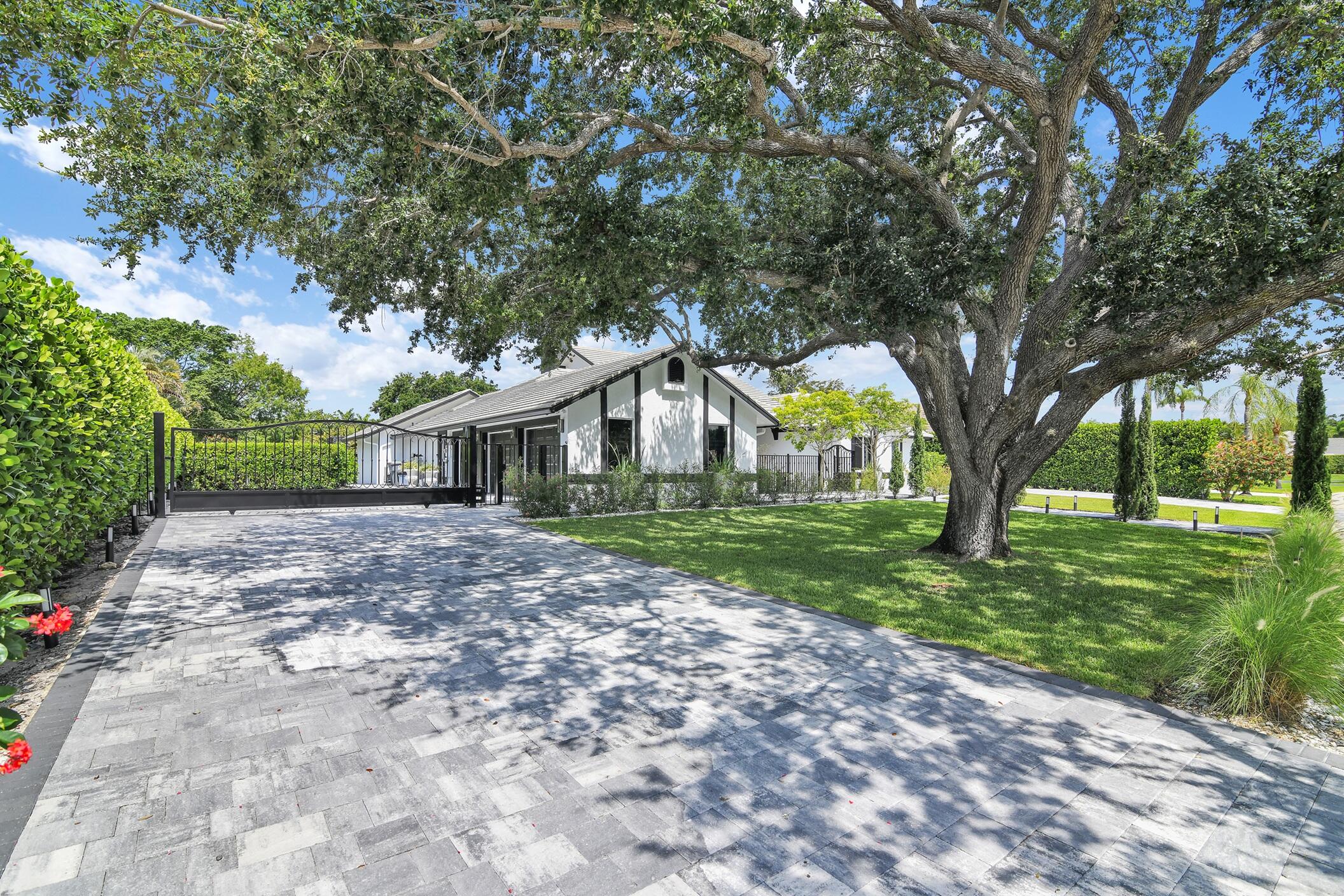 21082 North Sweetwater Lane Boca Raton, FL 33428 - Photo 3 of 75 a front view of a house with garden