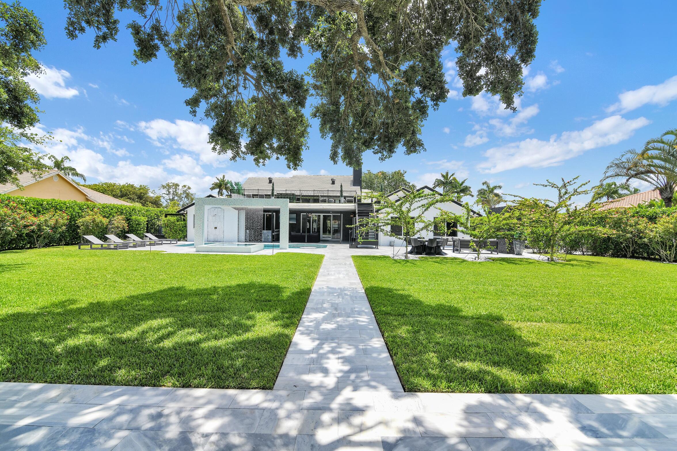 21082 North Sweetwater Lane Boca Raton, FL 33428 - Photo 47 of 75 a view of house with garden space and trees