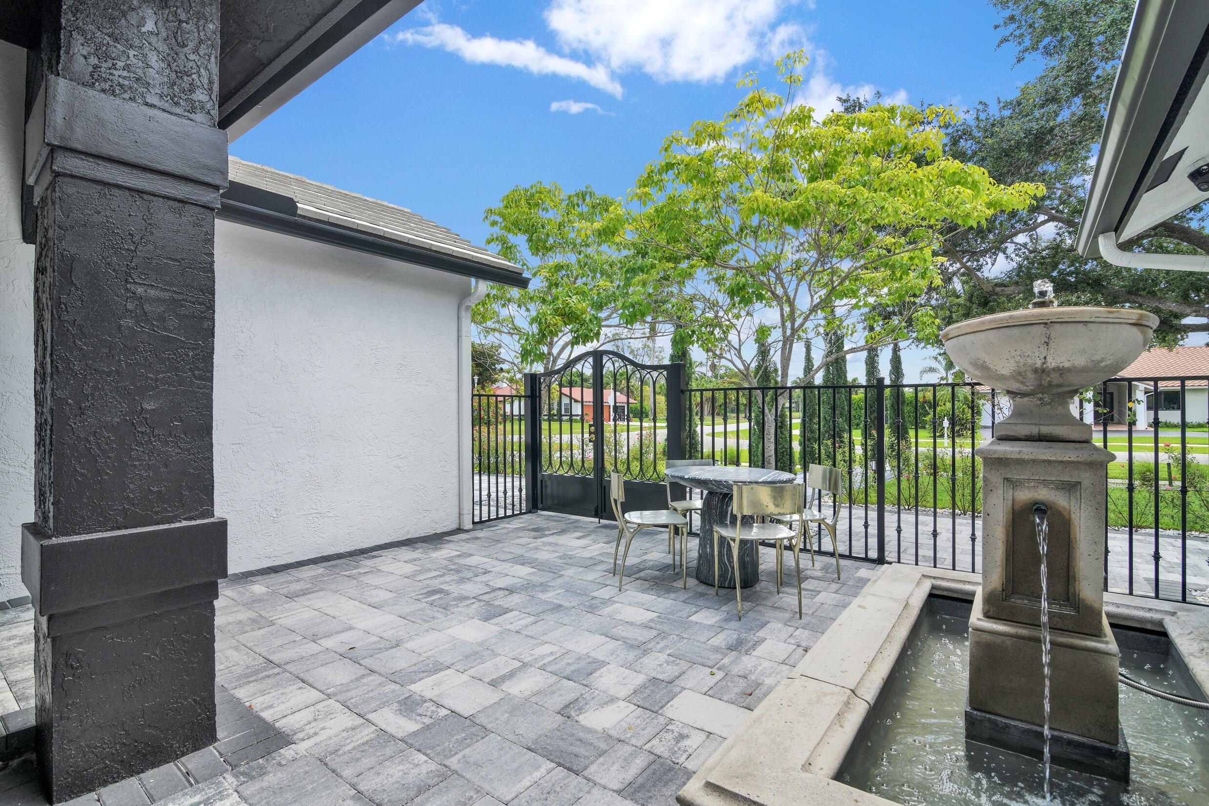21082 North Sweetwater Lane Boca Raton, FL 33428 - Photo 5 of 75 a view of a patio with couple of chairs and a fountain