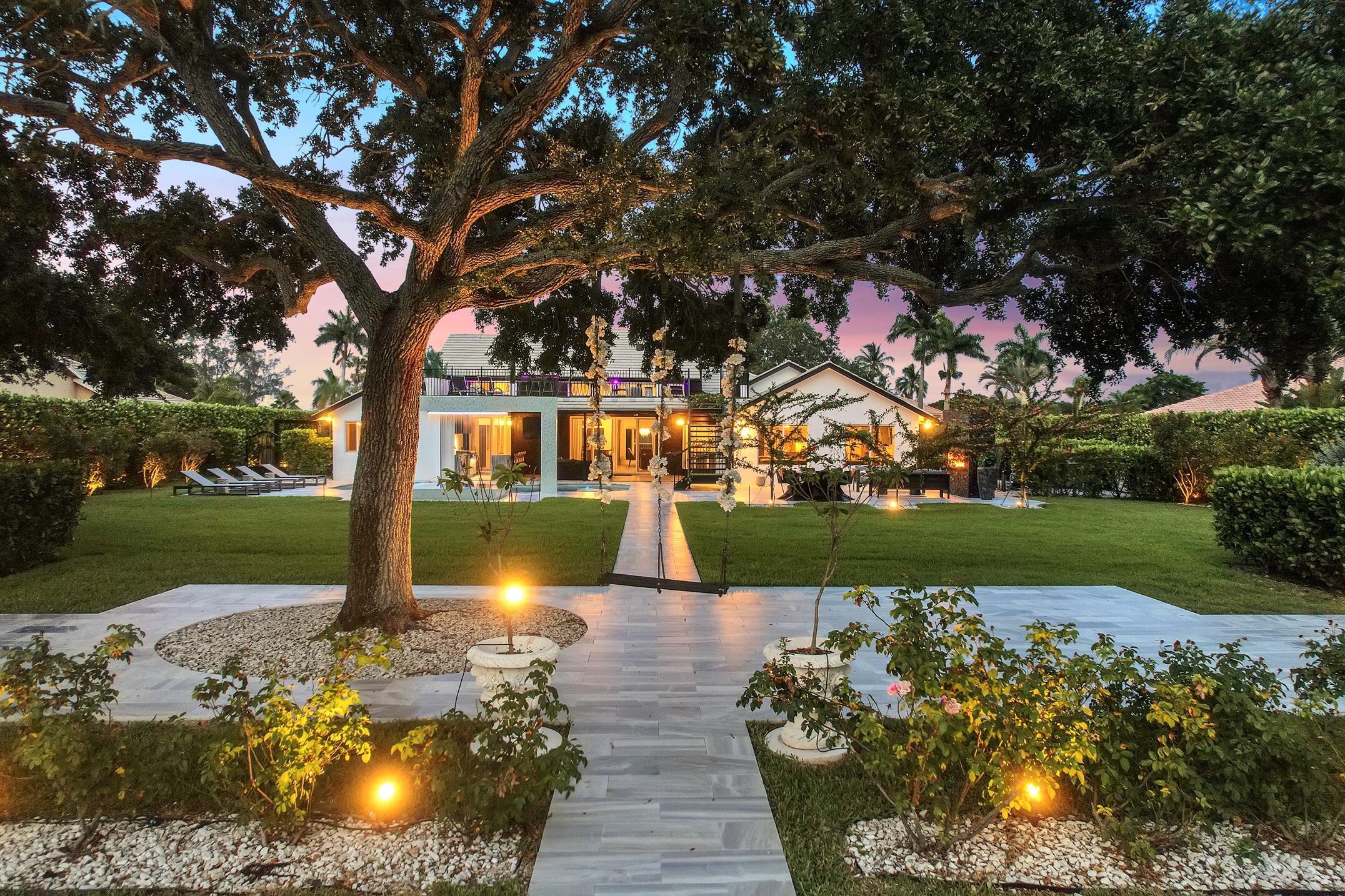 21082 North Sweetwater Lane Boca Raton, FL 33428 - Photo 74 of 75 a view of a lake with a bench and trees around