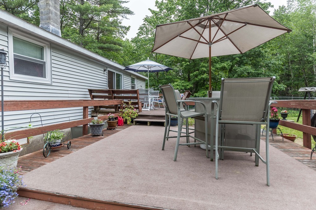 111 Sherbert Road Ashburnham, MA 01430 - Photo 15 of 18 a view of a patio with a table and chairs under an umbrella
