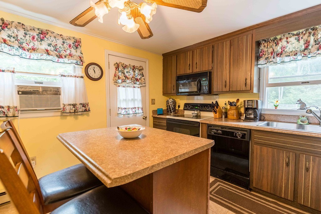 111 Sherbert Road Ashburnham, MA 01430 - Photo 2 of 18 a kitchen with a stove a sink and a refrigerator