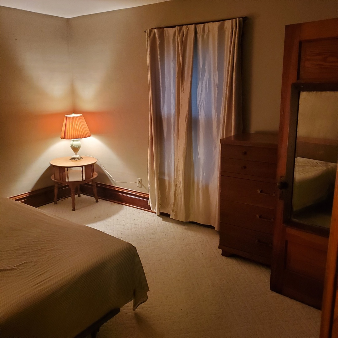 130 South 5th Street Sheldon, IL 60966 - Photo 21 of 28 a bedroom with a bed and a mirror