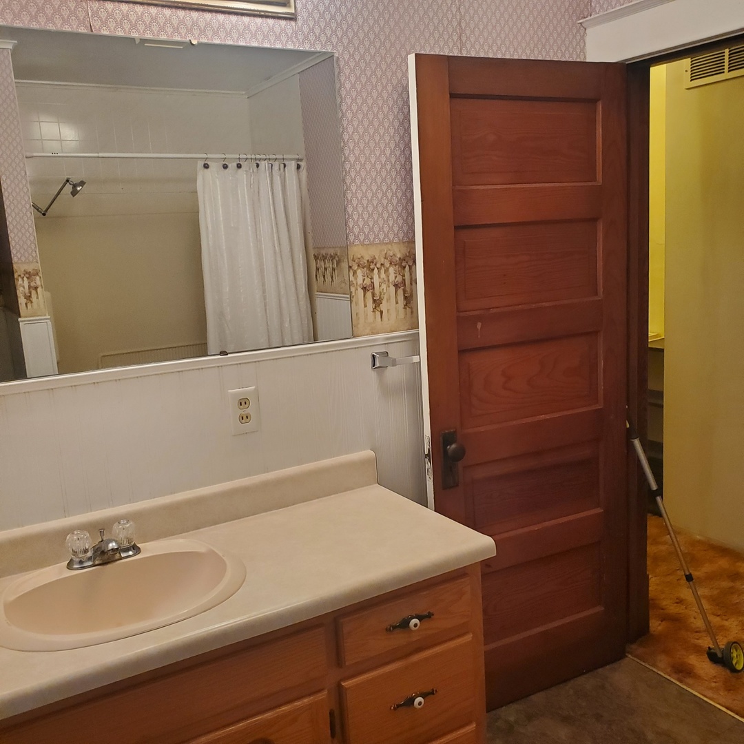130 South 5th Street Sheldon, IL 60966 - Photo 25 of 28 a bathroom with a sink and a mirror