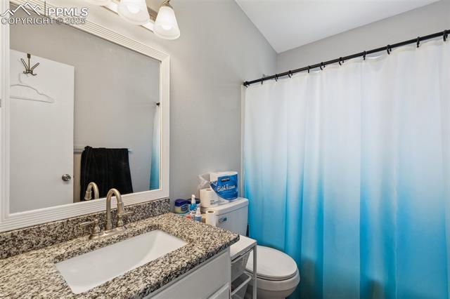 609 Wheat Field Road Fountain, CO 80817 - Photo 18 of 29 Bathroom with vanity and a shower with shower curtain