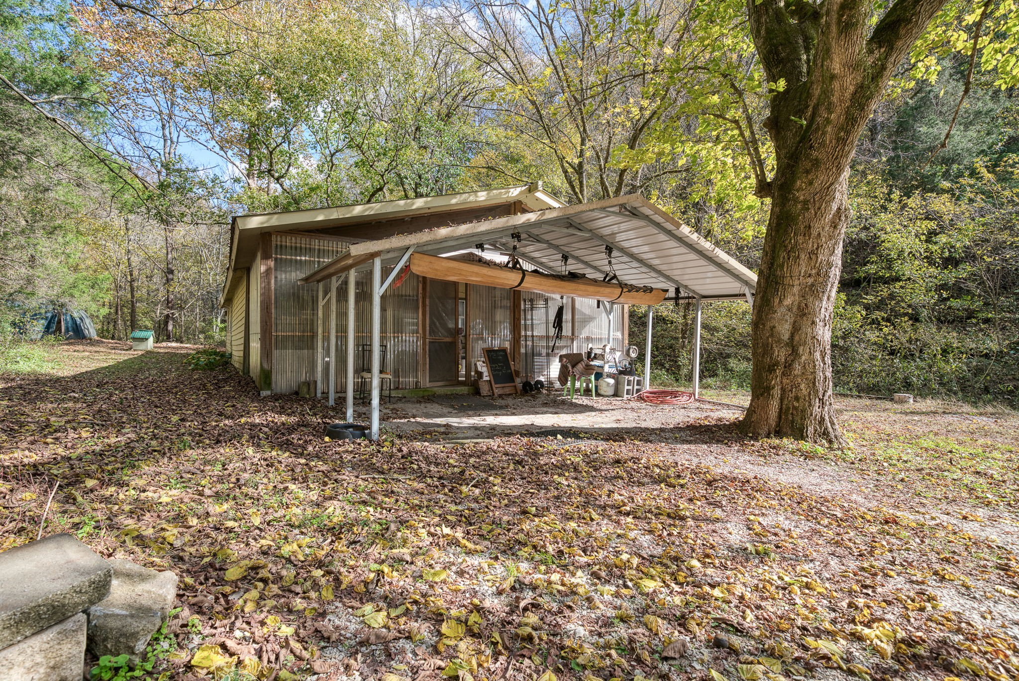 2087 Add Stafford Road Hilham, TN 38568 - Photo 25 of 43 a view of a barn with a large tree and a yard
