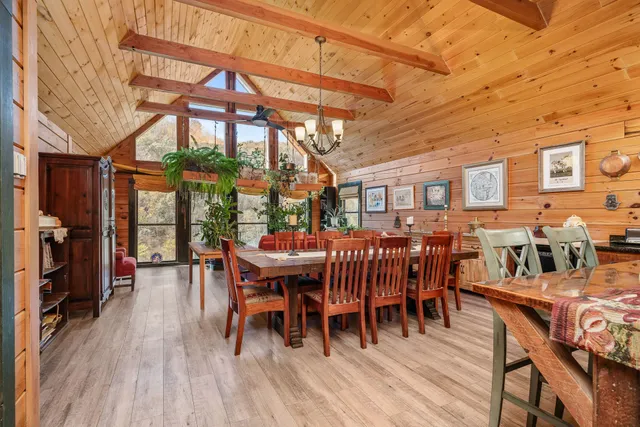 a dining room with furniture window and wooden floor