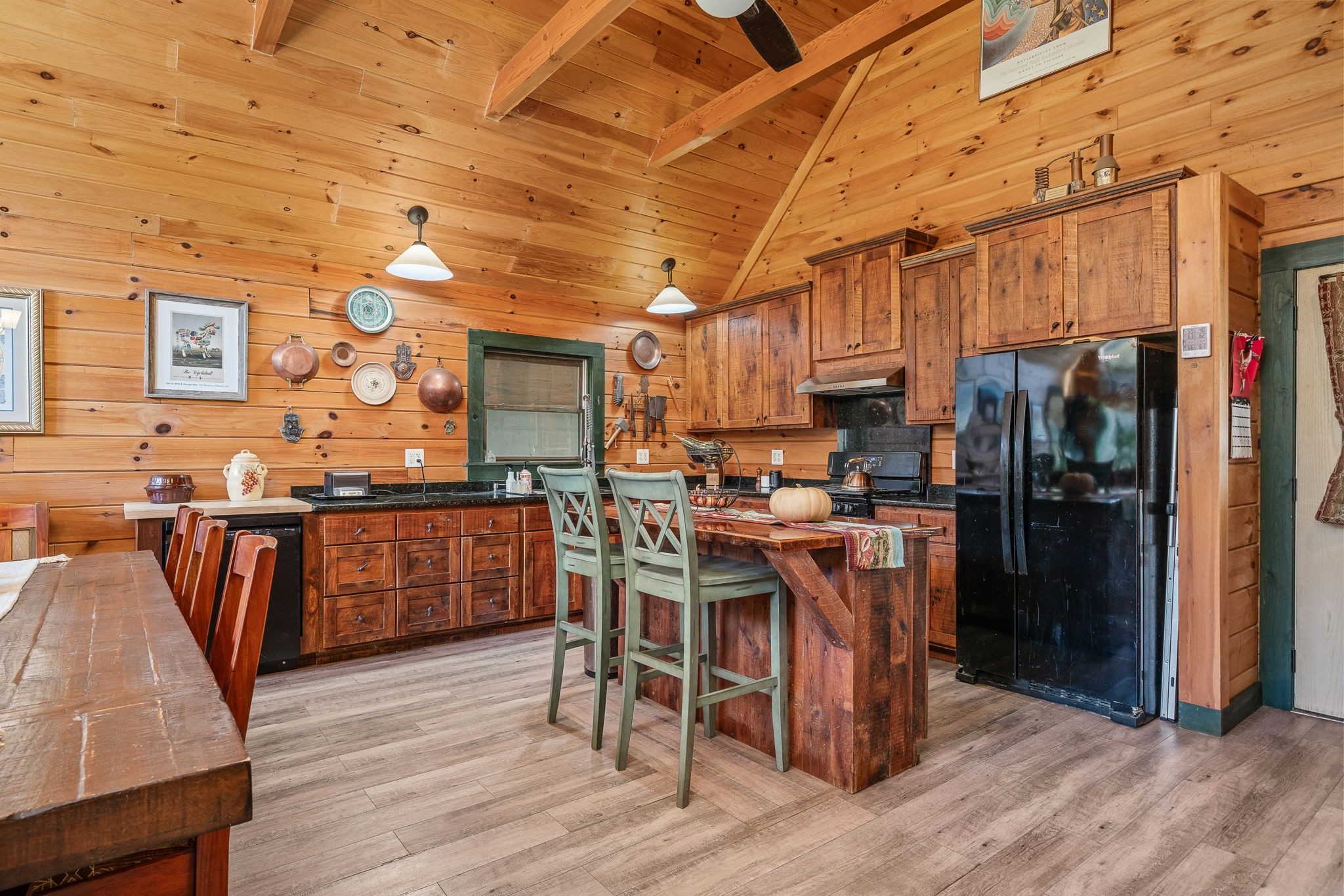 2087 Add Stafford Road Hilham, TN 38568 - Photo 7 of 43 a kitchen with stainless steel appliances a table chairs refrigerator and cabinets